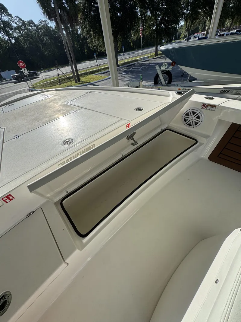 Slide: The Image of The image shows the deck of a 2027 Pathfinder 2500 Tournament boat with storage and a speaker. - 20