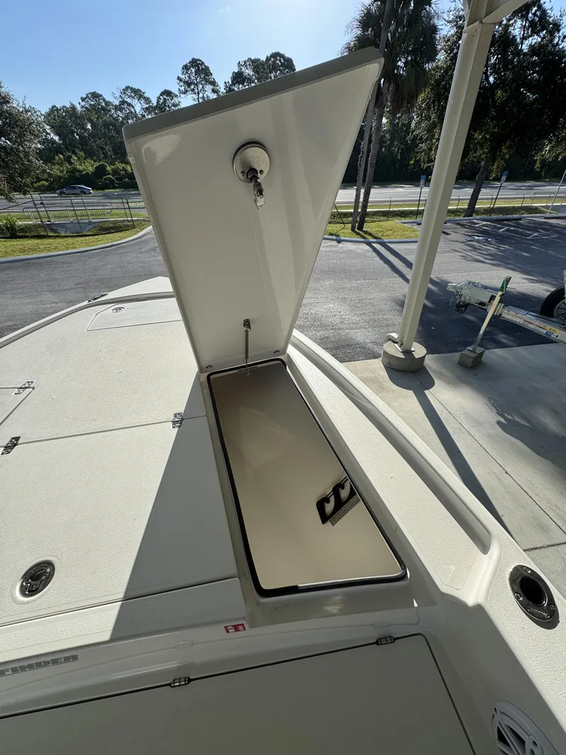 Slide: The Image of An open storage compartment on a 2027 Pathfinder 2500 Tournament boat, parked in a lot. - 14