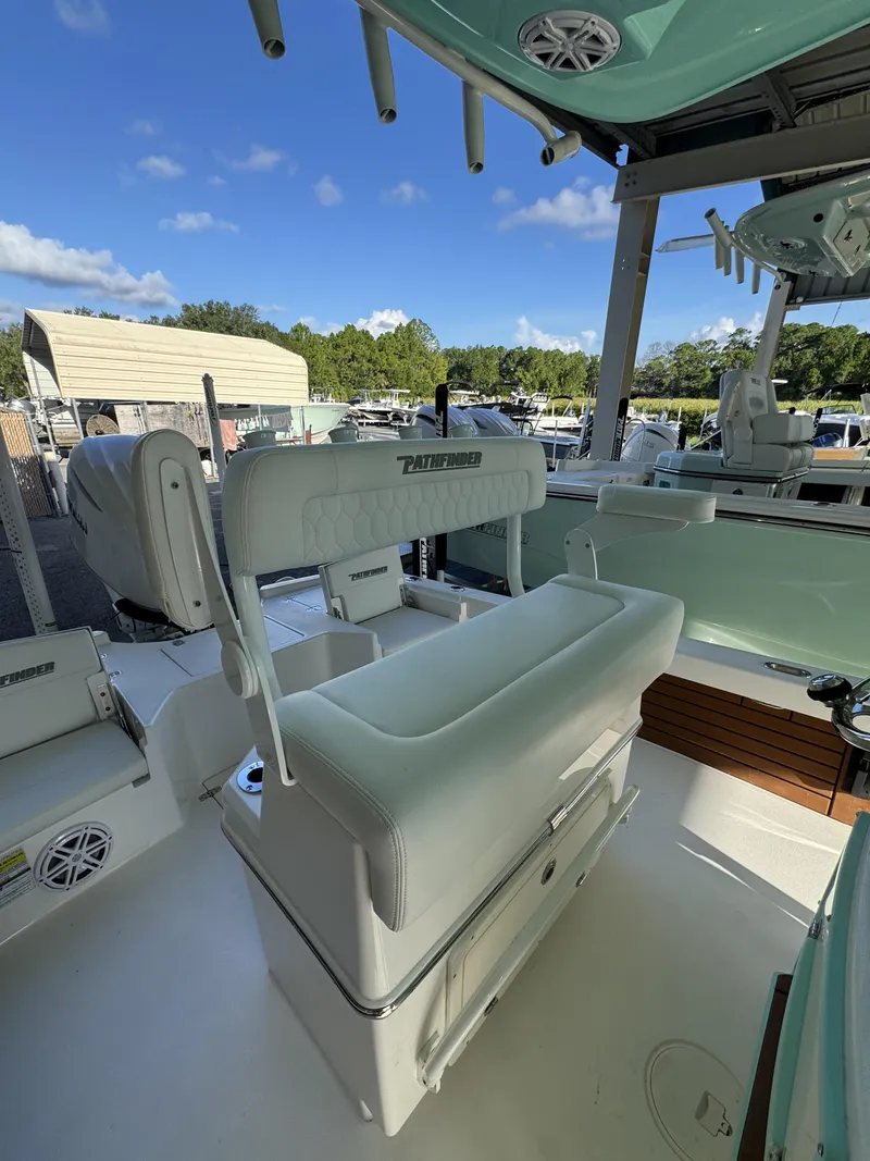 Slide: The Image of The image shows the cockpit of a 2027 Pathfinder 2500 Tournament boat with white seating. - 31