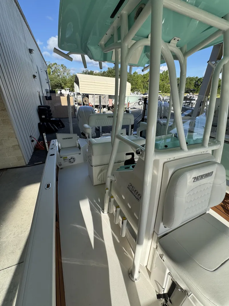 Slide: The Image of The image shows the deck of a Pathfinder 2500 Tournament boat with seating and fishing rod holders. - 29