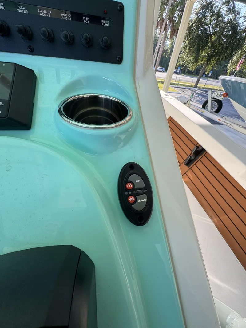 Slide: The Image of Close-up of a boat console area with control buttons and a cup holder. - 34