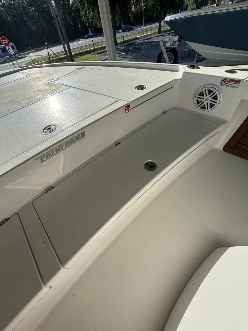 Slide: The Image of The image shows the deck of a 2027 Pathfinder 2500 Tournament boat with storage and a speaker. - 27