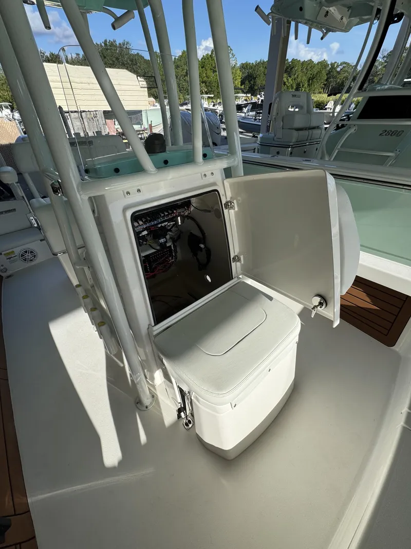 Slide: The Image of An open storage compartment on a 2027 Pathfinder 2500 Tournament boat, surrounded by seating. - 26