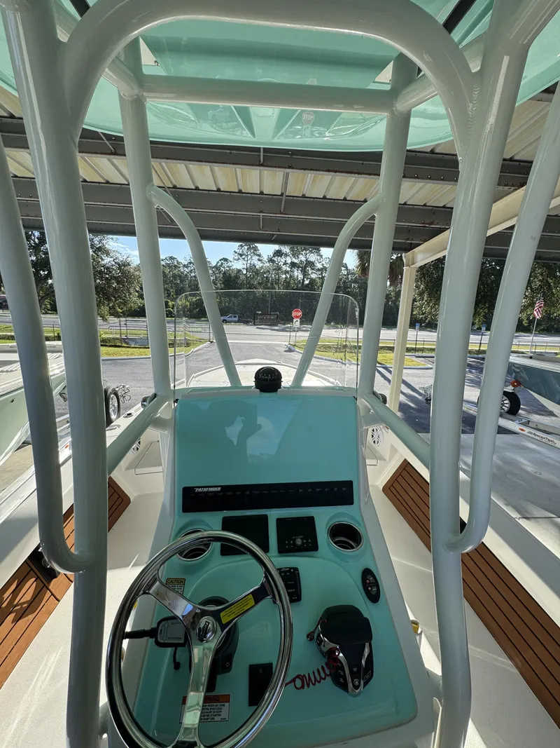 Slide: The Image of The image shows the helm of a 2027 Pathfinder 2500 Tournament boat with steering wheel and instruments. - 43
