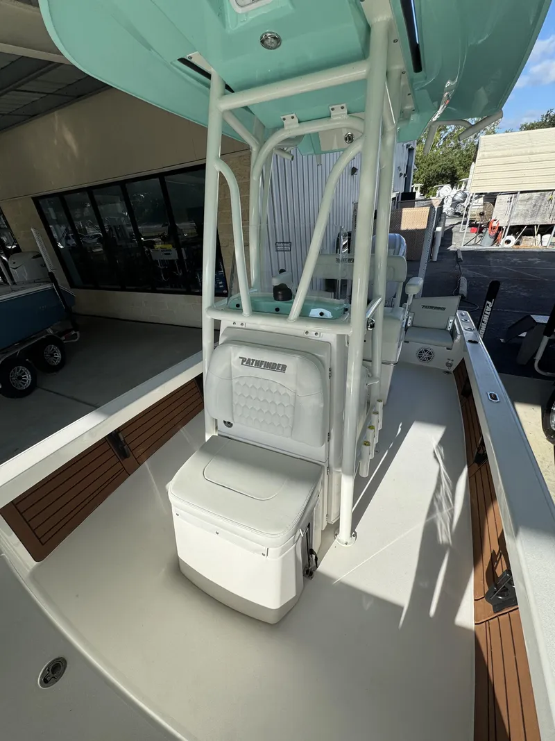 Slide: The Image of The image shows the cockpit of a 2027 Pathfinder 2500 Tournament boat with seating and storage. - 22