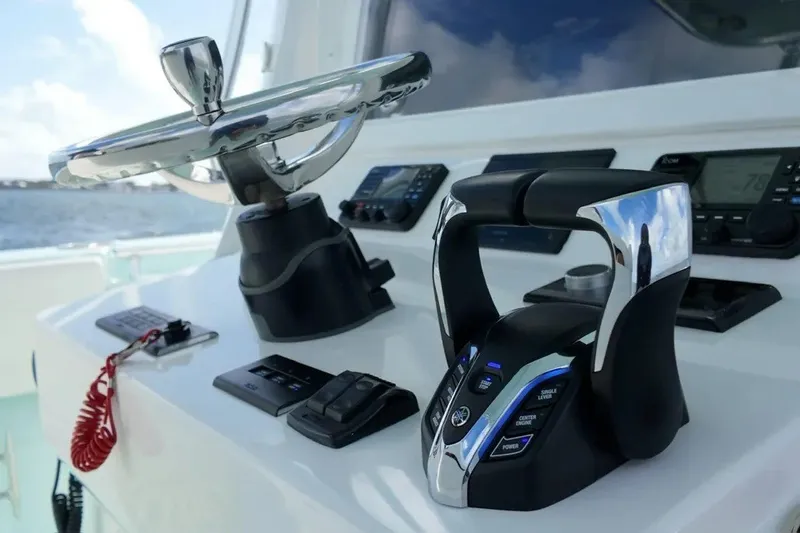 Slide: The Image of Helm of 2025 Contender 39 ST boat with modern controls and steering wheel. - 16
