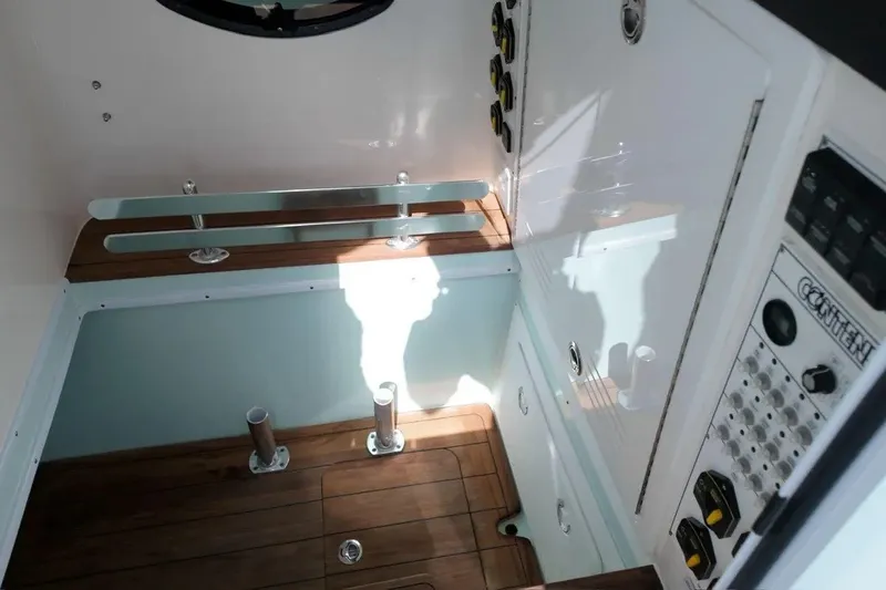 Slide: The Image of Interior view of 2025 Contender 39 ST boat, featuring sleek controls and wooden flooring. - 18