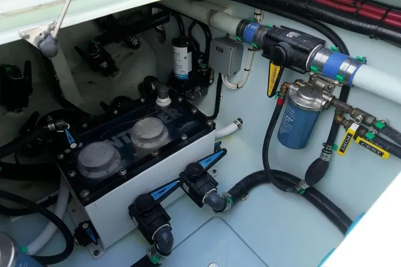 Slide: The Image of Engine compartment of 2025 Contender 39 ST boat, showcasing fuel and filtration systems. - 19