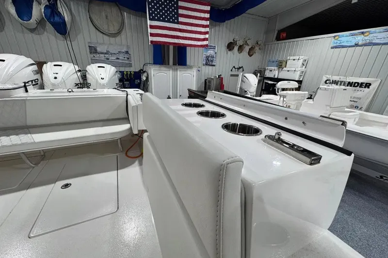 Slide: The Image of 2024 Contender 44 ST boat interior with seating, rod holders, and American flag display. - 37