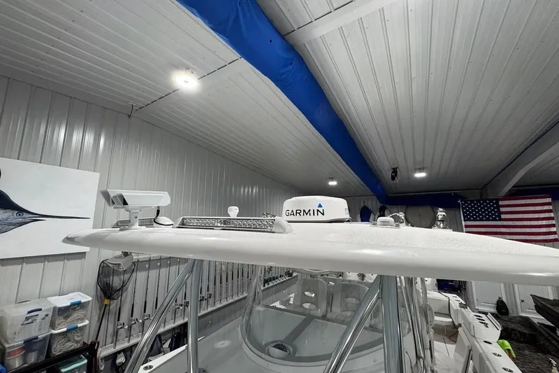 Slide: The Image of 2024 Contender 44 ST boat with Garmin equipment in a garage setting. - 40