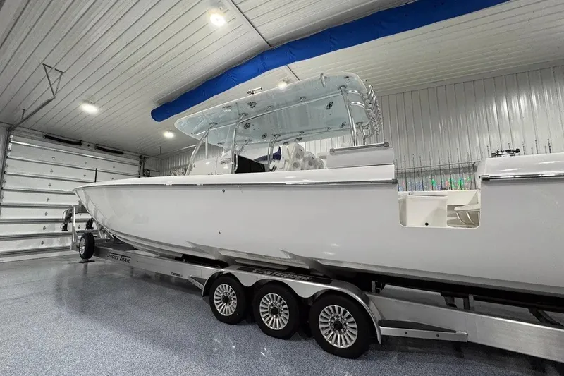 Slide: The Image of 2024 Contender 44 ST boat on trailer in a spacious indoor garage. - 42