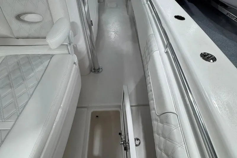 Slide: The Image of 2024 Contender 44 ST boat interior with white quilted seating and storage compartment. - 34