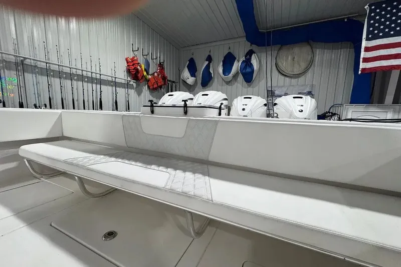 Slide: The Image of 2024 Contender 44 ST boat interior with seating, fishing rods, and life jackets. - 20