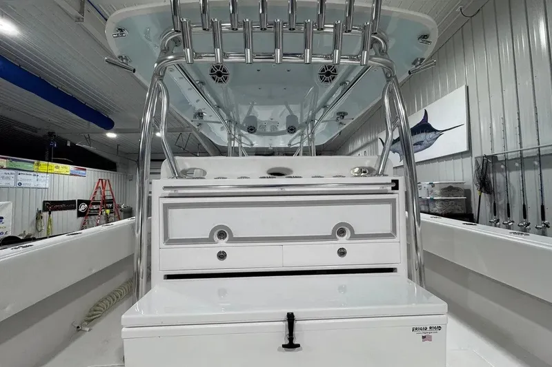 Slide: The Image of 2024 Contender 44 ST boat interior with storage compartments and fishing rod holders. - 22