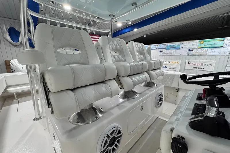 Slide: The Image of 2024 Contender 44 ST boat interior with luxurious white seating and modern controls. - 14