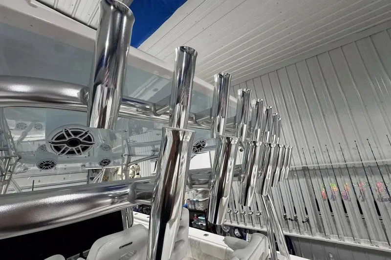 Slide: The Image of 2024 Contender 44 ST boat with polished rod holders and speakers in a sleek interior. - 39