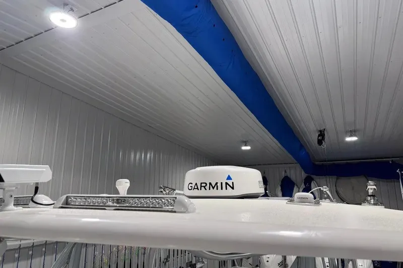 Slide: The Image of 2024 Contender 44 ST boat with Garmin radar in a well-lit indoor setting. - 41