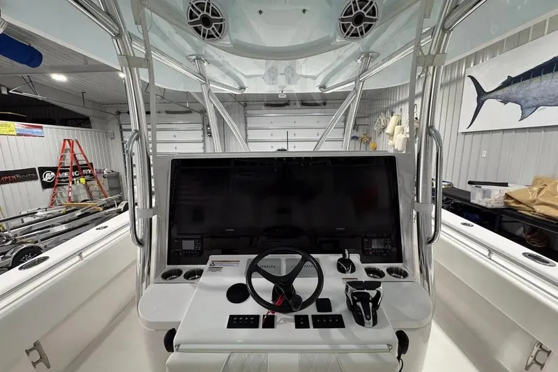 Slide: The Image of 2024 Contender 44 ST boat cockpit with advanced navigation system and steering wheel. - 16