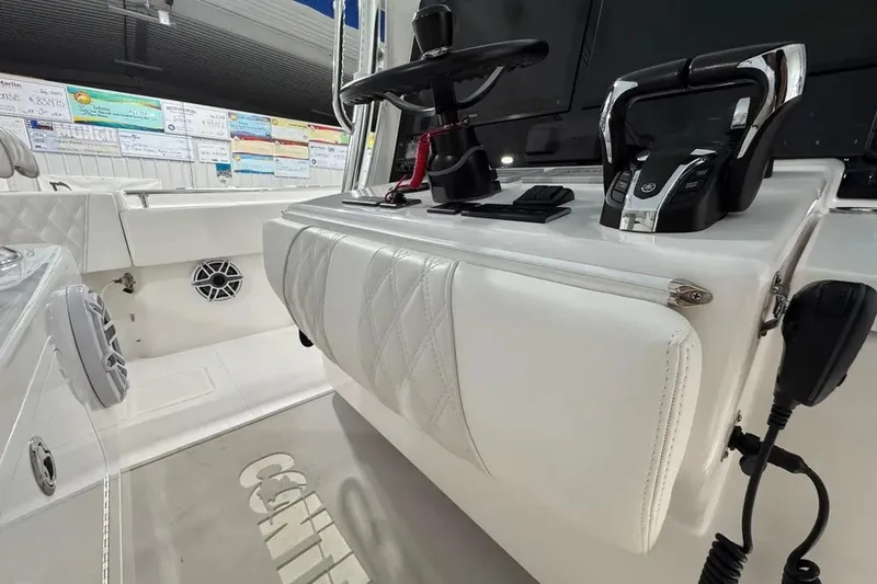 Slide: The Image of 2024 Contender 44 ST boat cockpit with steering wheel and controls. - 19