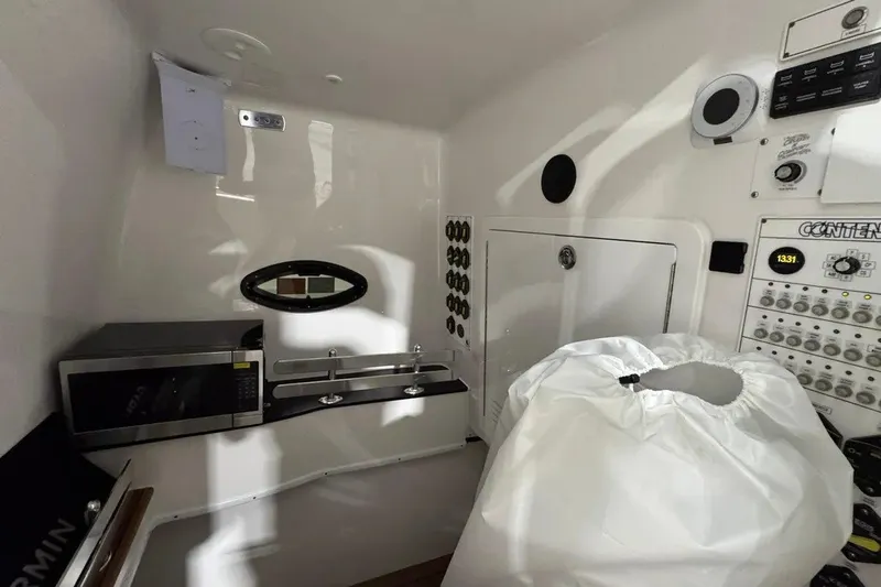 Slide: The Image of Interior of 2024 Contender 44 ST boat with microwave and control panel. - 28