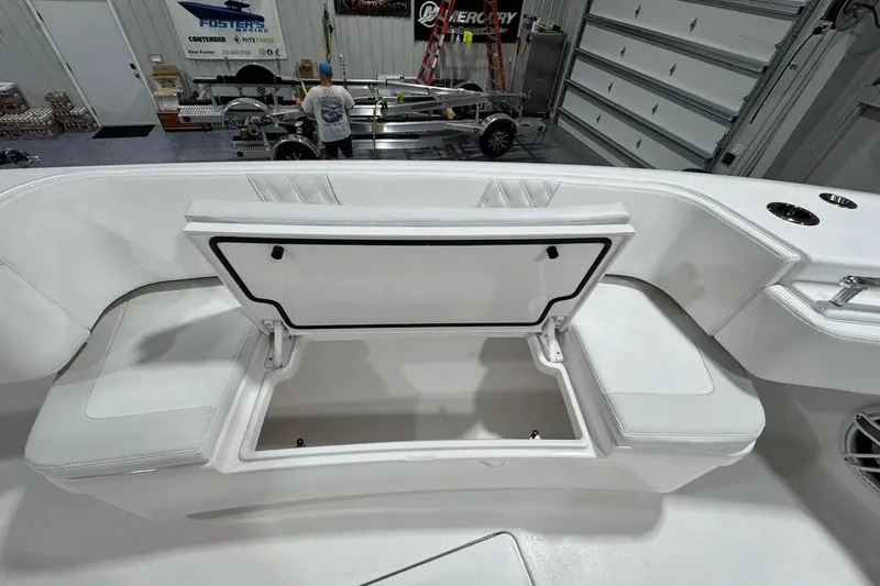 Slide: The Image of 2024 Contender 44 ST boat interior with open storage compartment in a workshop. - 29