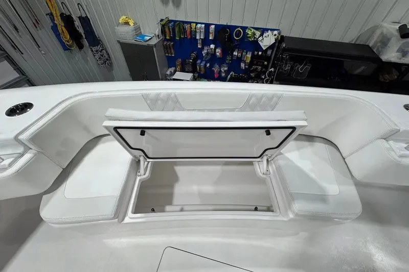 Slide: The Image of 2024 Contender 44 ST boat interior with open storage compartment, showcasing sleek white seating. - 31
