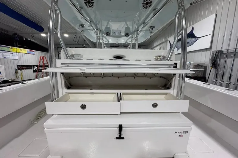Slide: The Image of 2024 Contender 44 ST boat interior with open storage compartments in a showroom. - 23