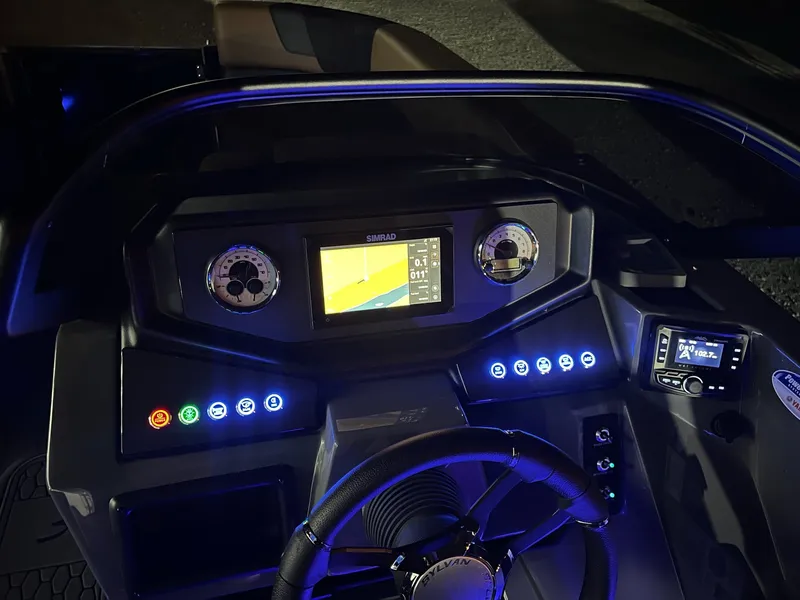 Slide: The Image of The dashboard of a 2026 Sylvan L3 RLZ with illuminated gauges and a screen. - 9