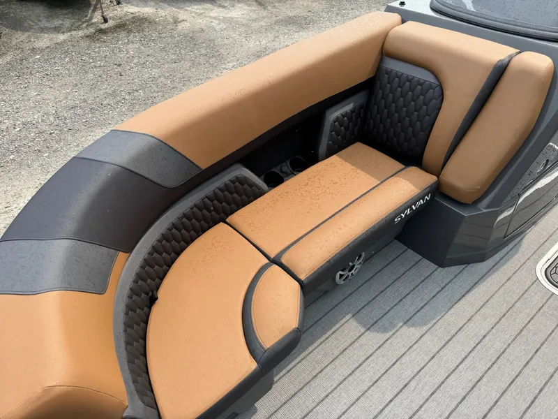 Slide: The Image of The image shows a luxurious, cushioned seating area on a boat with a brown and black design. - 16
