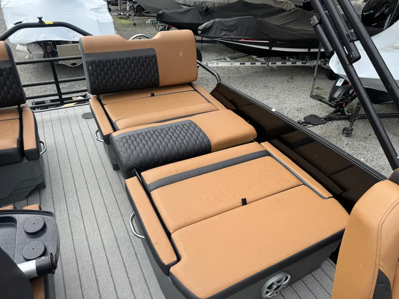 Slide: The Image of The image shows the seating of a 2026 Sylvan L3 RLZ boat with brown and black upholstery. - 10