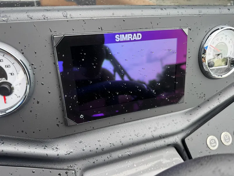 Slide: The Image of The image shows a boat cockpit with a Simrad display and a speedometer. - 26