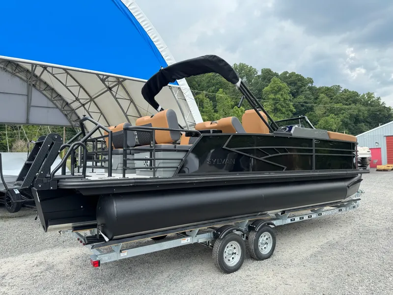 Slide: The Image of A 2026 Sylvan L3 RLZ pontoon boat on a trailer, set against a large tent. - 20