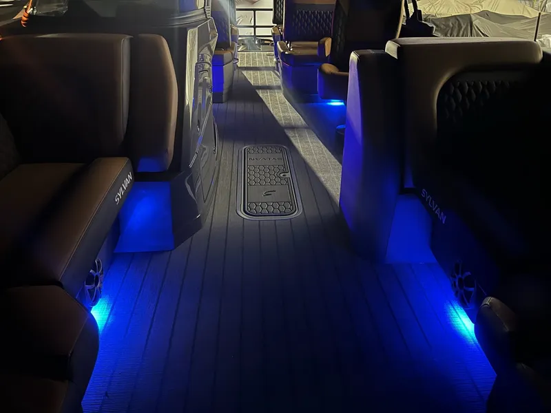 Slide: The Image of The image shows the interior of a Sylvan L3 RLZ boat with blue LED lighting. - 34