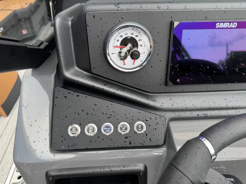 Slide: The Image of Close-up of a Sylvan L3 RLZ boat's helm with a tachometer and Simrad display. - 36