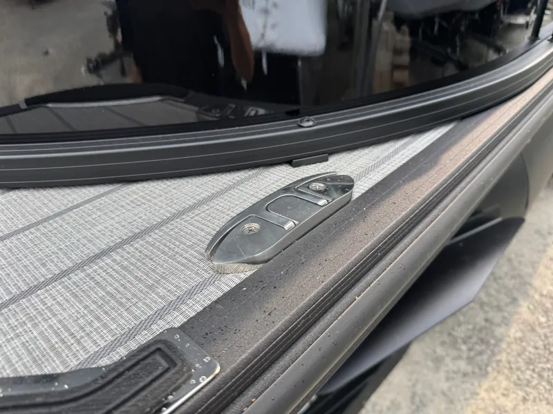 Slide: The Image of Close-up of a boat deck with metal fittings and textured flooring. - 39