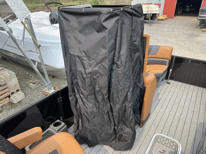 Slide: The Image of The image shows the interior of a Sylvan L3 RLZ boat with brown seats and a black cover. - 22