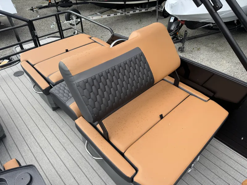 Slide: The Image of The image shows the seats of a 2026 Sylvan L3 RLZ boat with brown and gray upholstery. - 5