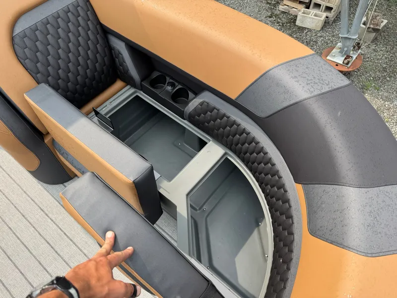 Slide: The Image of The image shows part of the interior of a 2026 Sylvan L3 RLZ with stylish seating and built-in storage. - 12