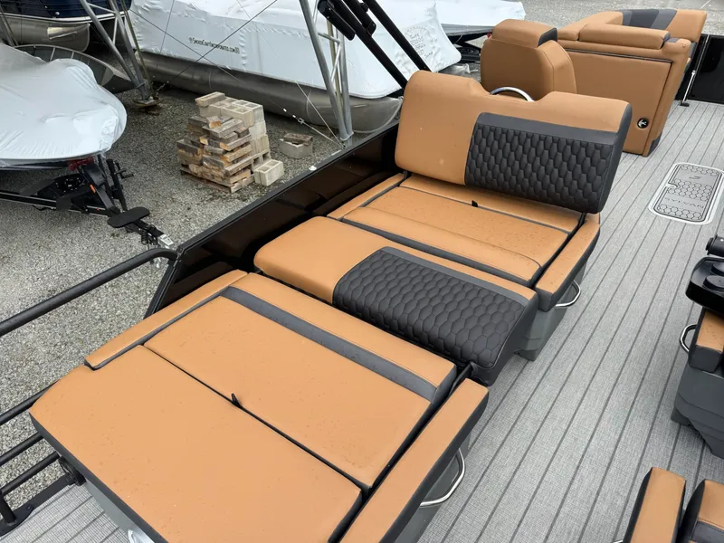 Slide: The Image of The image shows the lounging area of a 2026 Sylvan L3 RLZ boat with cushioned seats. - 31