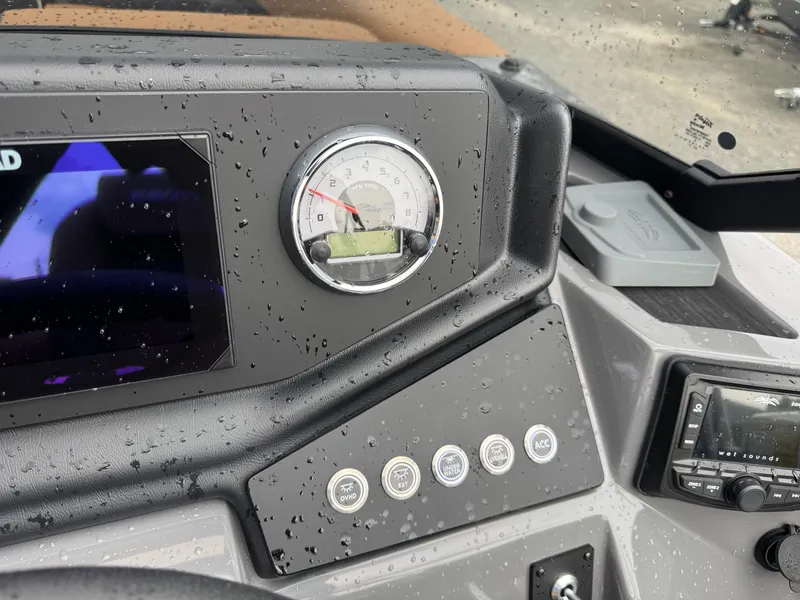 Slide: The Image of The dashboard of a Sylvan L3 RLZ boat with a speedometer and various controls. - 11