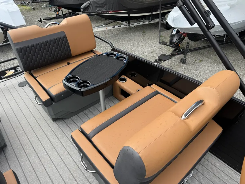 Slide: The Image of The image shows the seating area of a 2026 Sylvan L3 RLZ boat with a central table. - 21