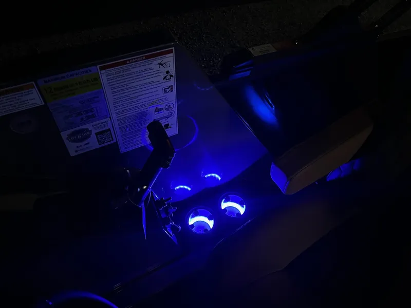 Slide: The Image of The image shows an illuminated helm of a Sylvan L3 RLZ boat with blue lights. - 32