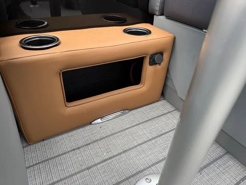 Slide: The Image of Interior of a 2026 Sylvan L3 RLZ with brown upholstery and cup holders. - 40