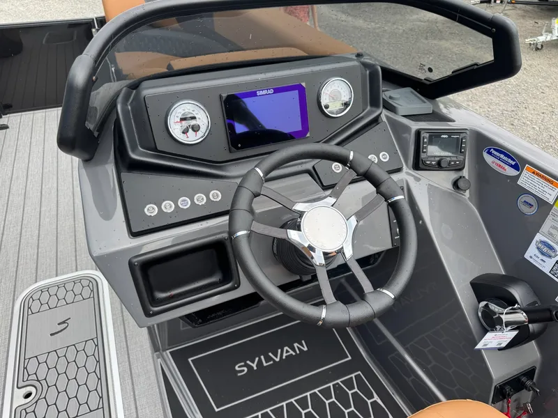 Slide: The Image of The image shows the helm of a Sylvan L3 RLZ boat with modern instruments and a steering wheel. - 24