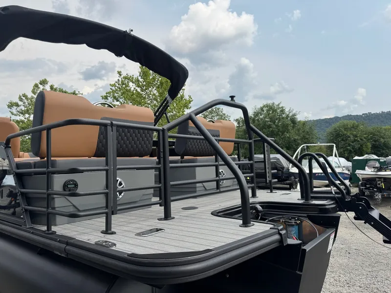 Slide: The Image of The image shows a modern pontoon boat with beige seats and black railing. - 7