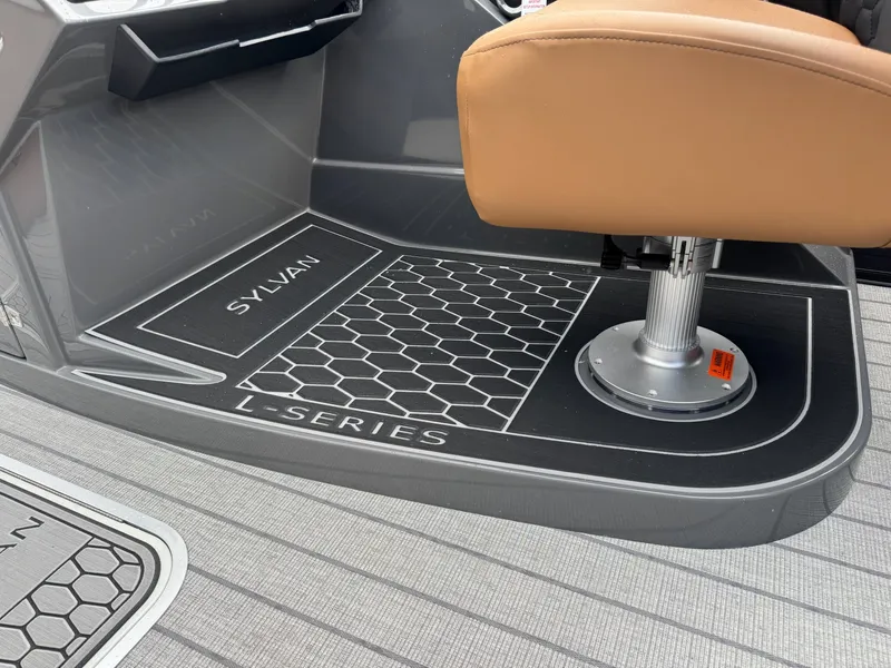 Slide: The Image of Close-up of a boat deck with a swivel seat and Sylvan L-Series branding. - 27