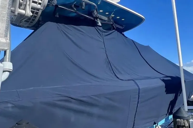 Slide: The Image of 2024 Contender 30 Tournament boat covered with a blue tarp under clear sky. - 3