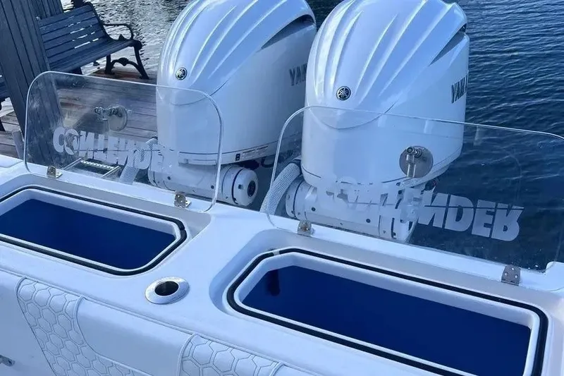 Slide: The Image of 2024 Contender 30 Tournament boat with dual Yamaha outboard engines, docked by the water. - 24