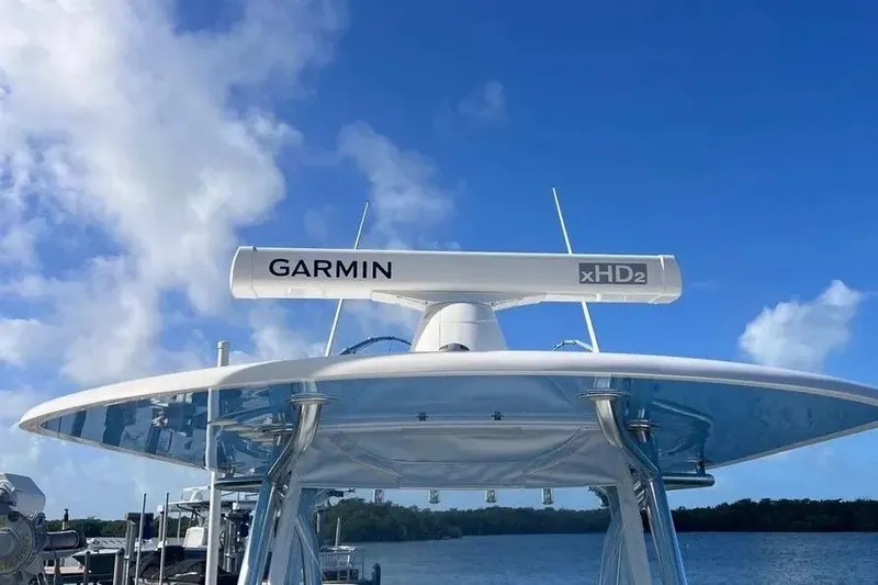 Slide: The Image of 2024 Contender 30 Tournament boat with Garmin xHD2 radar against a clear blue sky. - 13