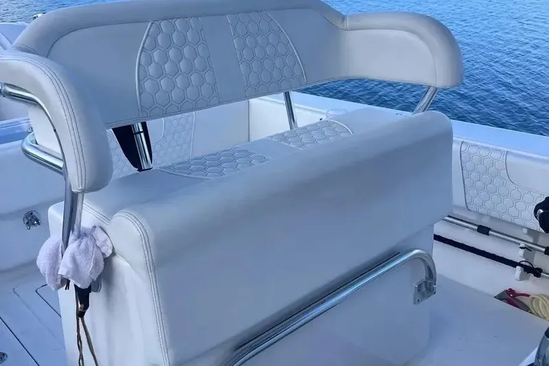 Slide: The Image of 2024 Contender 30 Tournament boat seating with hexagonal pattern, overlooking water. - 15